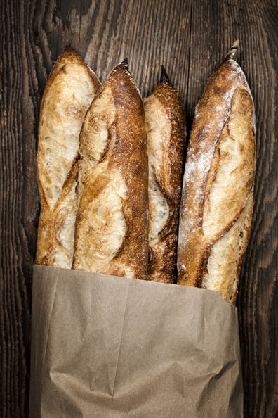 Baguette bread loves in a paper bag.