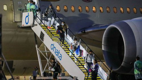 Tennis players and their support teams are seen disembarking Flight EY460 carrying tennis players and their support teams participating at the Australian Open at Melbourne Jet Base adjoining the Melbourne International airport on January 14, 2021 in Melbourne, Australia