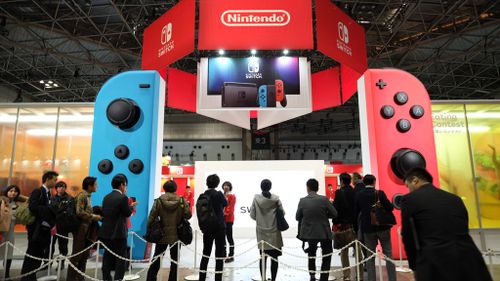 People make line up for Nintendo's new video game console Switch during its presentation in Tokyo on January 13, 2017. (AFP)