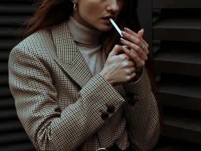 Stock photo of a woman smoking a cigarette.