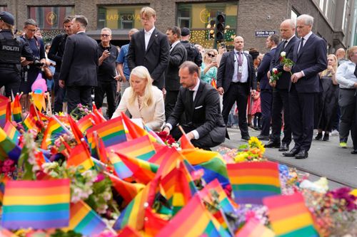 Norway's Crown Prince Haakon, Crown Princess Mette-Marit and Prime Minister Jonas Gahr Stoere, right, visit the scene of a shooting in central Oslo, Norway, Saturday, June 25, 2022. 