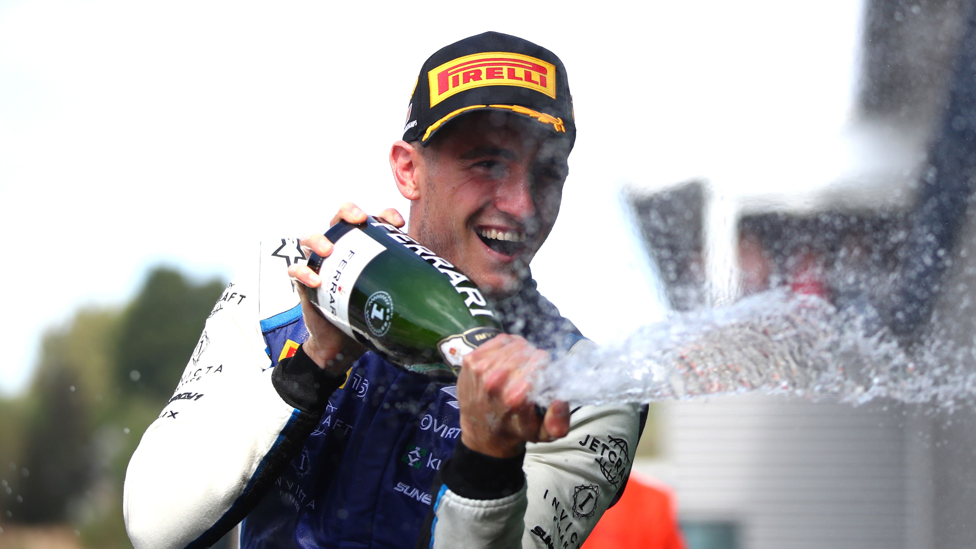 F2 driver Jack Doohan spraying champagne on the podium after winning the F2 feature race at the Belgian grand prix.