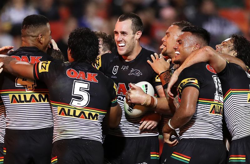Isaah Yeo of the Panthers celebrates with his teammates after scoring a try.