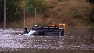 NSW Police rescue man from ute stuck in floodwaters.