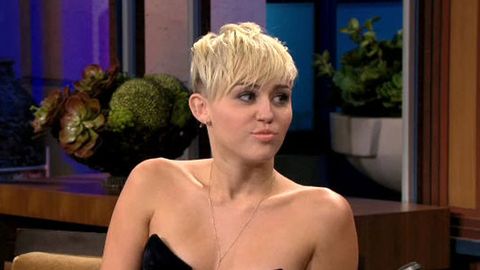 Watch: Miley Cyrus almost pops out of top on Jay Leno, he talks to her chest