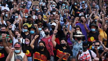 Activists take part in an &#x27;Invasion Day - Day of Mourning&#x27; rally at Town Hall in Sydney.