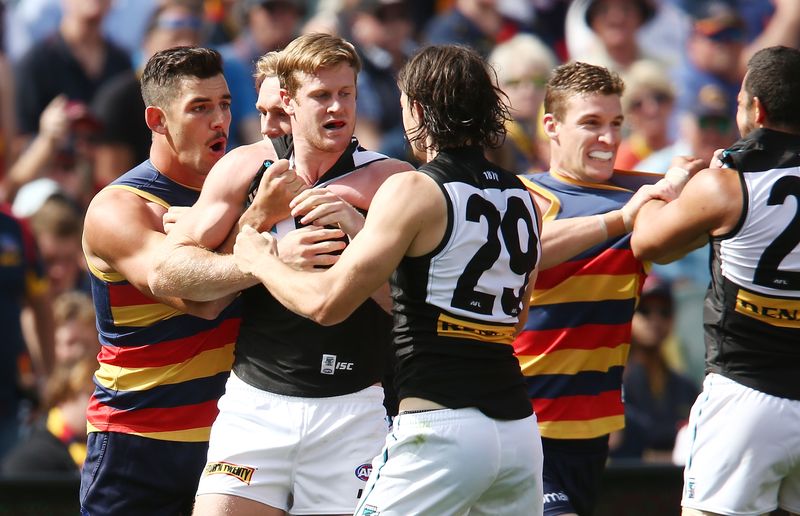 Tom Jonas gets involved in a scuffle with Adelaide Crows players.
