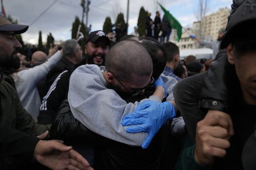 Palestinian prisoners are greeted by a crowd after being released from Israeli prison following a ceasefire agreement with Israel, in the West Bank city of Ramallah, Saturday, Jan. 25, 2025. (AP Photo/Nasser Nasser)