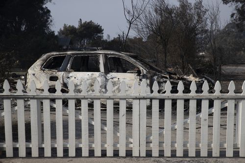A car and home destroyed but the picket fence remains standing in the famed suburb of Malibu.