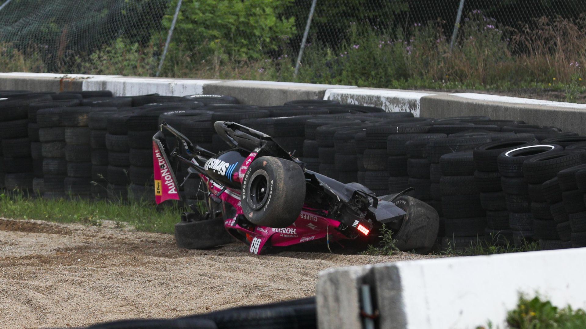 Simon Pagenaud&#x27;s car lays upsidedown after crashing heavily at Mid-Ohio.