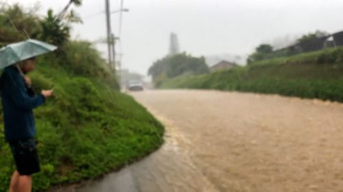 Water rushes down the street in the Maui, Hawaii, community called Haiku, on Monday.