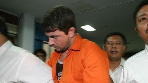 Brazilian drug smuggler Rodrigo Gularte escorted by Indonesian National Drug Bureau officers shortly after he was shown to journalists at an airport, in Tangerang, Banten, Indonesia. (AAP)