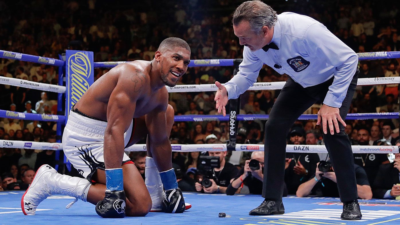 Anthony Joshua waits during the referee's count after he was knocked down during the seventh round 