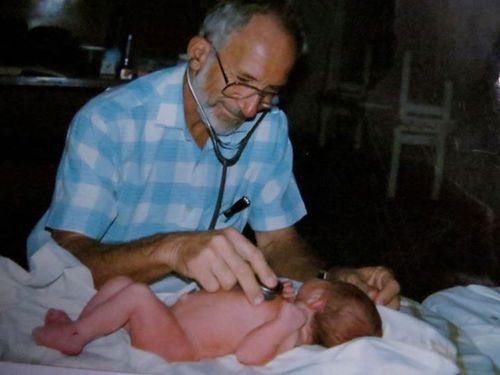Dr Ken Elliot treats a baby. 