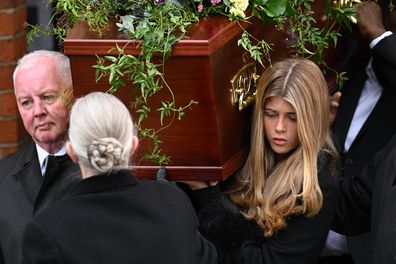 Darcey Draper, the daughter of Derek Draper, carries her father's coffin after the funeral mass at St Mary the Virgin Church, on February 2, 2024 in London 