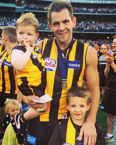 Hodge celebrates his second Norm Smith Medal with his family.