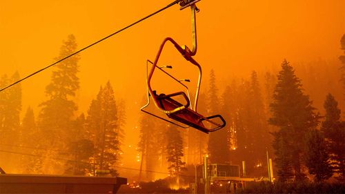 The Caldor Fire burns as a chairlift sits motionless at the Sierra-at-Tahoe ski resort in Eldorado National Forest.