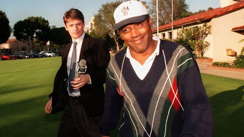 O.J. Simpson smiles as he walks away from reporters after playing a round of golf at Rancho Park Golf course in Los Angeles in 1997.