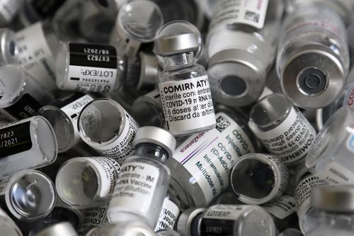 In this file photo dated Saturday, May 15, 2021, empty vials of the Pfizer-BioNTech COVID-19 vaccine lie in a box during a vaccine campaign in Ebersberg near Munich, Germany. (AP Photo/Matthias Schrader, FILE)