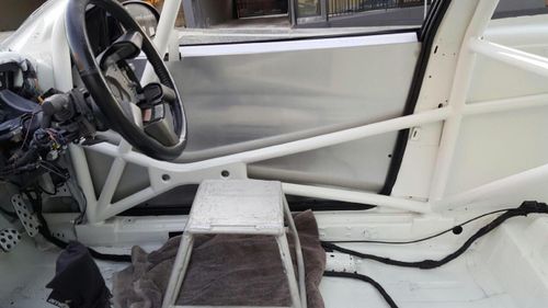 The interior flooring and dashboard protection had been removed from the Commodore and a roll-bar installed. Picture: Supplied.