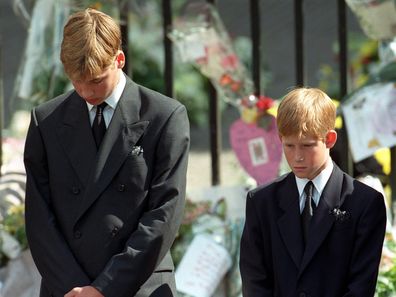 Prince William (left) and Prince Harry, the sons of Diana, Princess of Wales, bow their heads as their mother's coffin is taken out of Westminster Abbey following her funeral service. 