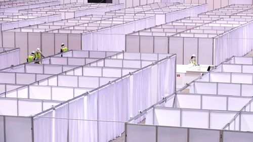 Workers set up an "alternate care facility" at McCormick Place Hall A in Chicago.