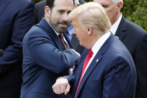 Bruce Greenstein elbow bumps with President Donald Trump during a news conference about the coronavirus.