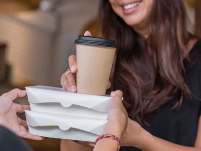 Woman buying takeaway coffee