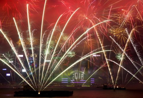 Fireworks explode over the Victoria Harbor during New Year's Eve to celebrate the start of year 2018 in Hong Kong, Monday, Jan. 1, 2018.  (AAP)
