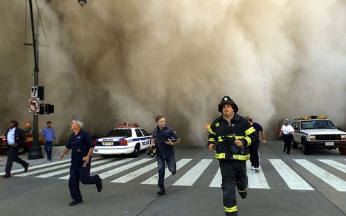 First responders fleeing a dust cloud after the collapse of the World Trade Centre. (AFP)