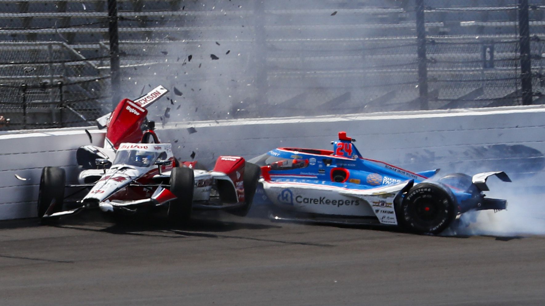 Katherine Legge (left) and Stefan Wilson crash in the first turn during practice for the Indianapolis 500.