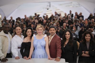 Greta Gerwig, centre, poses with jury members Omar Sy, from left, Lily Gladstone, Eva Green, Pierfrancesco Favino, Nadine Labaki, and Ebru Ceylan at Cannes Film Festival 2024