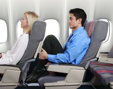 Man with no leg room on flight