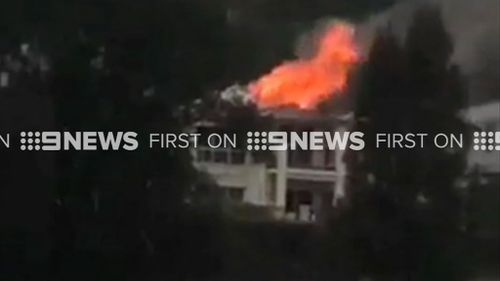 A house in Sydney's Huntley's Cove caught fire during the thunderstorm. (9NEWS)