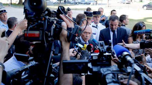 French Interior Minister Gerard Collomb speaks to reporters after a driver rammed a car carrying explosives into a police convoy on the Champs-Elysees avenue, in Paris. (AAP)