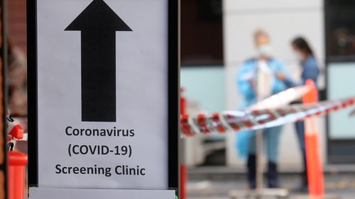 MELBOURNE, AUSTRALIA - MARCH 11: A sign directing people to the COVID-19 screening area is posted outside the Royal Melbourne Hospital on March 11, 2020 in Melbourne, Australia. Seven coronavirus screening clinics are now open in Victoria to help avoid the further spread of COVID-19. 18 people in Victoria have now been diagnosed with the virus, with the Australian total of confirmed cases now at 100.(Photo by Luis Ascui/Getty Images)