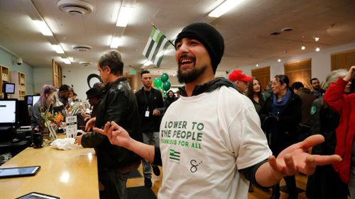 An ecstatic customer after making a purchase and wearing his free t-shirt at the Harborside cannabis dispensary in Oakland, California. (AAP)
