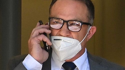 Michael Slater has been charged with assaulting a man at a Sydney hospital.