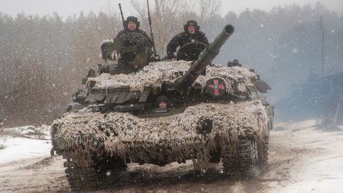 A Ukrainian tank moves during military drills close to Kharkiv, Ukraine, Thursday, Feb. 10, 2022. Britain's top diplomat has urged Russia to take the path of diplomacy even as thousands of Russian troops engaged in sweeping maneuvers in Belarus as part of a military buildup near Ukraine. (AP Photo/Andrew Marienko)