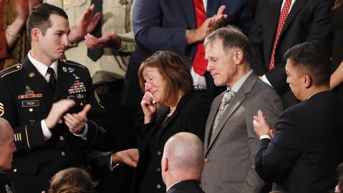 Cindy and Fred Warmbier (centre) react as Mr Trump describes their son's fatal ordeal in North Korean custody. (AAP)