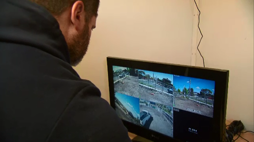 Robert Illoski monitors the security cameras on the property.