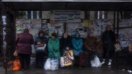 Women wait at a bus station in Kramatorsk, Ukraine, Thursday, April 14, 2022.