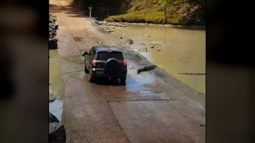 Video shows the moment the 4WD was attempting to drive through Cahills Crossing in Arnhem Land when it was forced to stop due to a group of slow-moving crocodiles in its path.