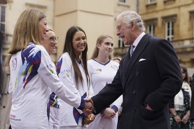 King Charles III meets torch bearers, at the start of the Australian Legacy Torch Relay to mark the beginning of the London-leg of the charity's relay race in celebration of their centenary year at Buckingham Palace in London, Friday April 28, 2023 