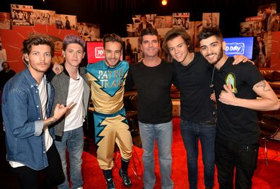 Louis Tomlinson, Niall Horan, Liam Payne, Simon Cowell, Harry Styles, and Zayn Malik on set during One Direction celebrates 1D Day at YouTube Space LA in Playa Vista, California on November 23, 2013