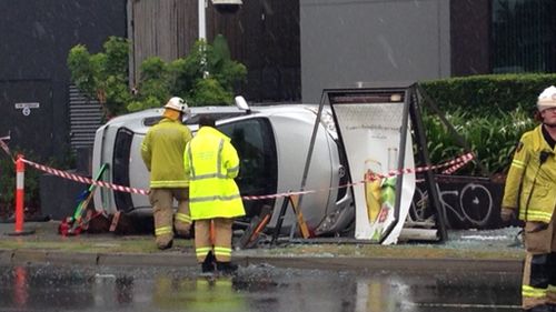 Car rollover closes lanes, downs powerlines on Coronation Drive, Toowong