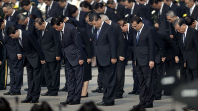 Chinese President Xi Jinping, center, and other officials bow during a ceremony to mark Martyr's Day at Tiananmen Square in Beijing, Monday, Sept. 30, 2019. 