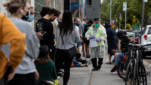 People queue outside a Covid-19 testing site in Collingwood  in Melbourne.