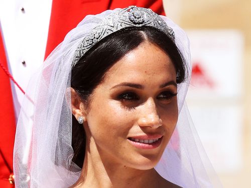 Holding Meghan's veil in place was Queen Mary's 1932 diamond and platinum bandeau tiara.