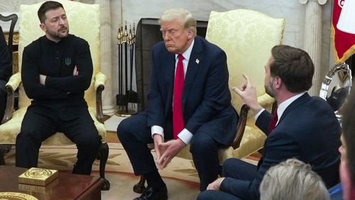 Vice President JD Vance, right, speaks with Ukrainian President Volodymyr Zelenskyy, left, as President Donald Trump listens in the Oval Office at the White House on February 28. 2025.